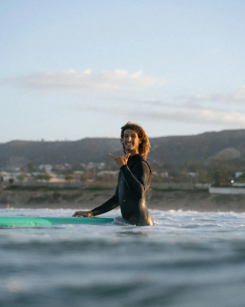 Mohamed, co-founder of Flow House, surfing in Tamraght